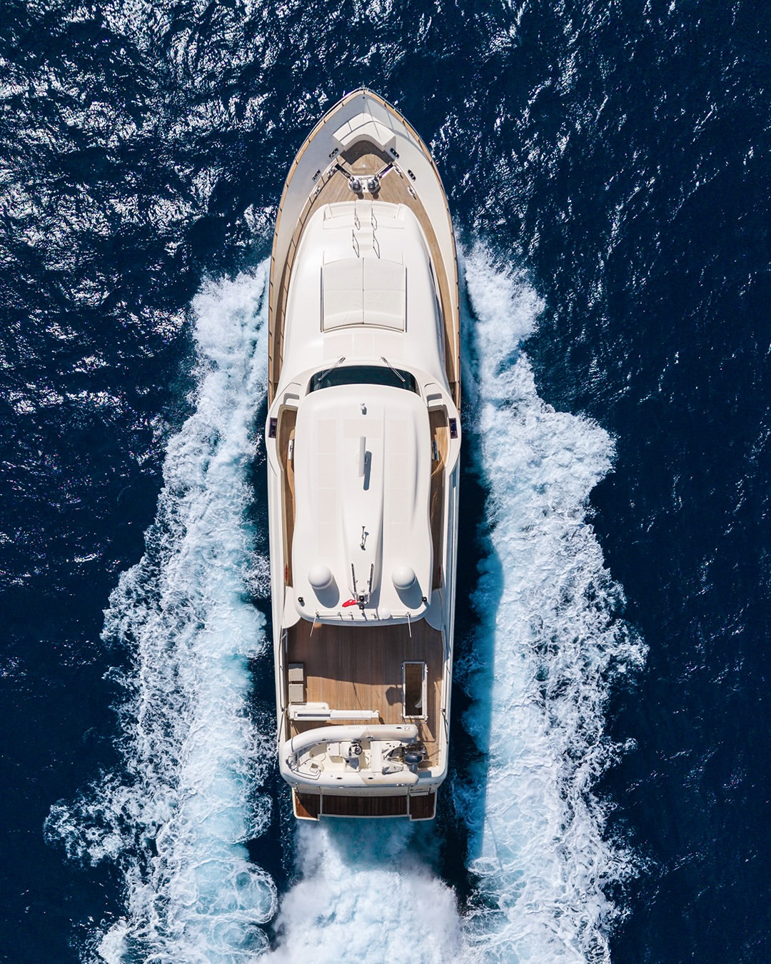 Top-down aerial view of the Custom Line Navetta 26 (2008) underway, highlighting its deck layout and motor yacht profile.