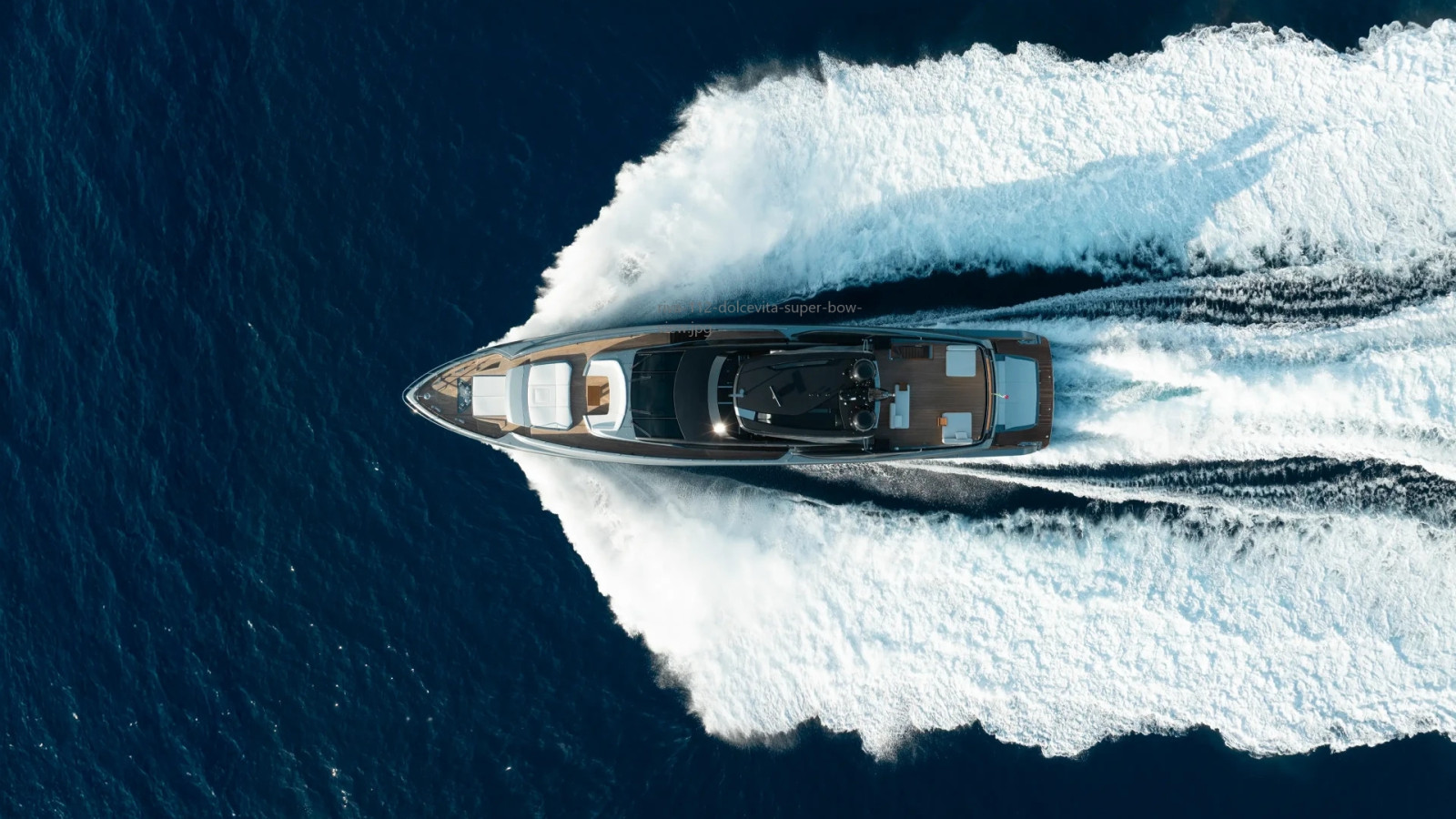 Aerial view of the Riva 112' Dolcevita Super cruising at speed, revealing its streamlined profile and performance.