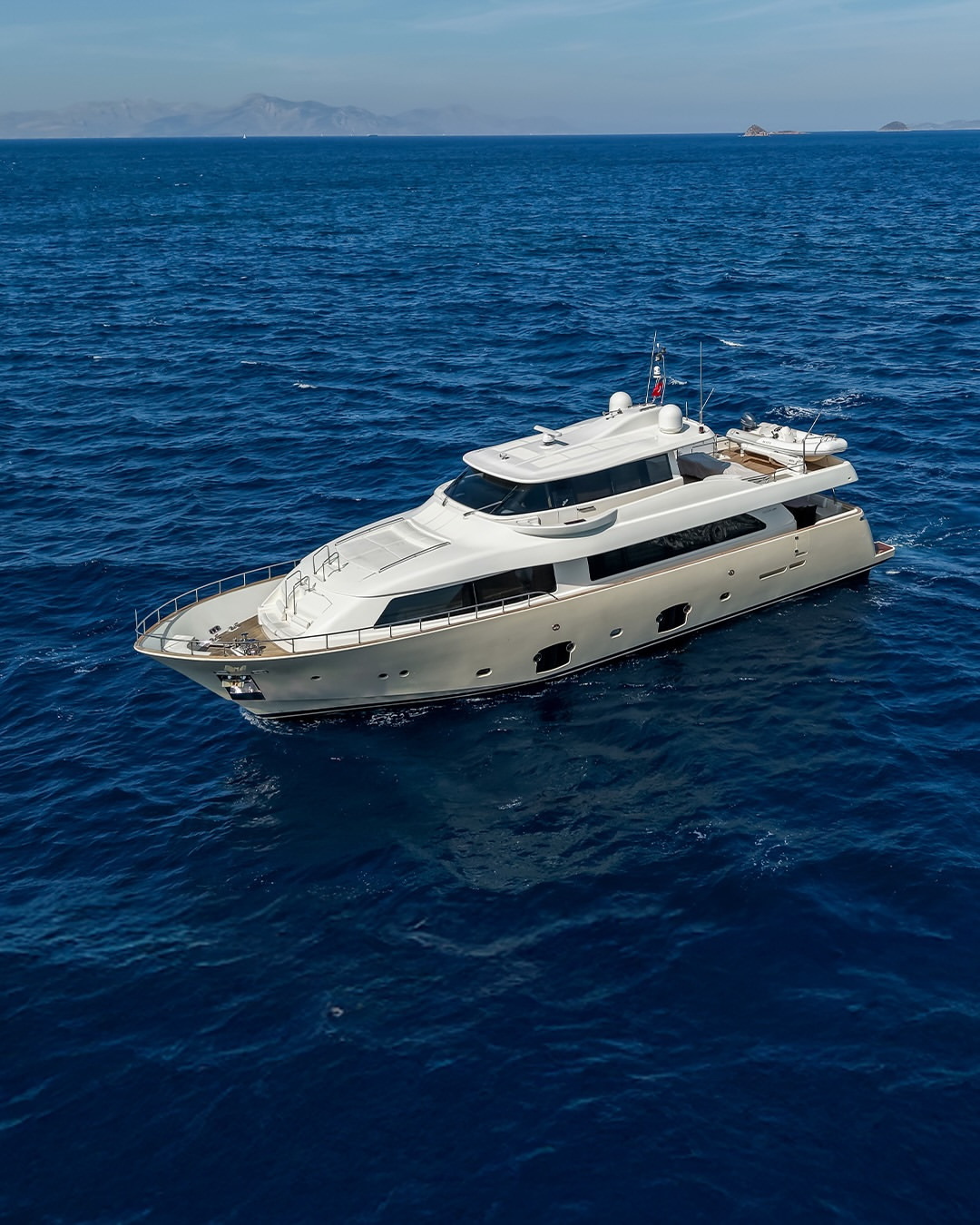 Custom Line Navetta 26 (2008) exterior profile at sea, featuring the yacht’s distinctive superstructure and spacious decks.