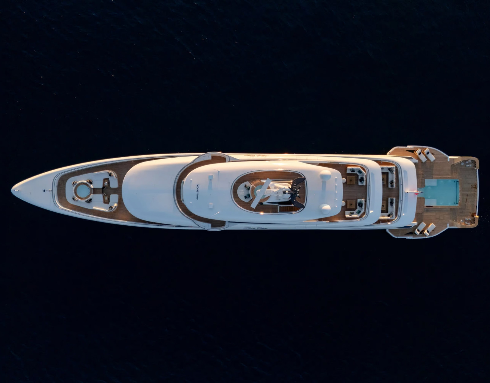 Top-down aerial view of the Benetti B.Now 67M revealing its full deck arrangement, helipad area and expansive aft pool deck.